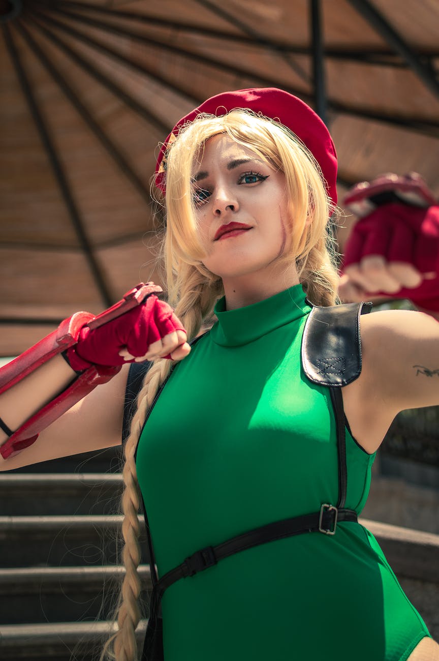 a cosplayer with blonde hair and red hat